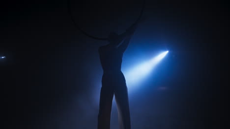 aerial hoop performance in a dark room