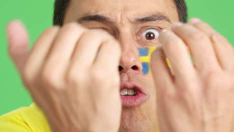 man with swedish national flag upset with a referee