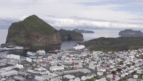 aerial of small town vestmannaeyjar in remote archipelago of iceland, pan right