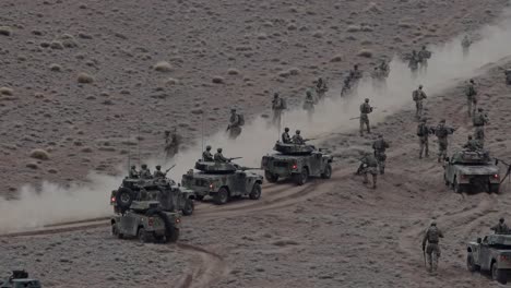 aerial view of military vehicles and soldiers in desert terrain, showcasing strategic movement