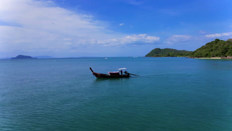 drone circling a long-tail boat (ruea hang yao) on the andaman ocean in thailand