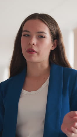 lady teacher explains material to students. young woman in office uniform tells visitors rules of behaviour in college library to avoid violations