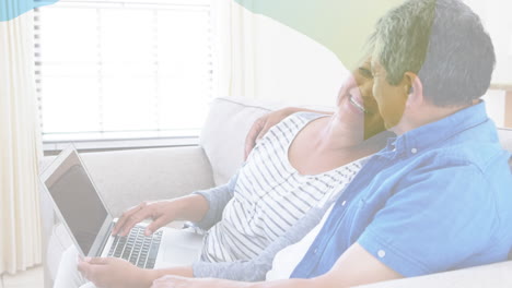 animation of shapes over senior biracial couple using laptop