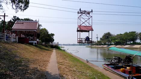 cable car crossing river with boats docked