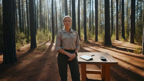 a park ranger standing in a pine forest
