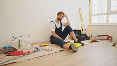 tired construction worker sitting on the floor