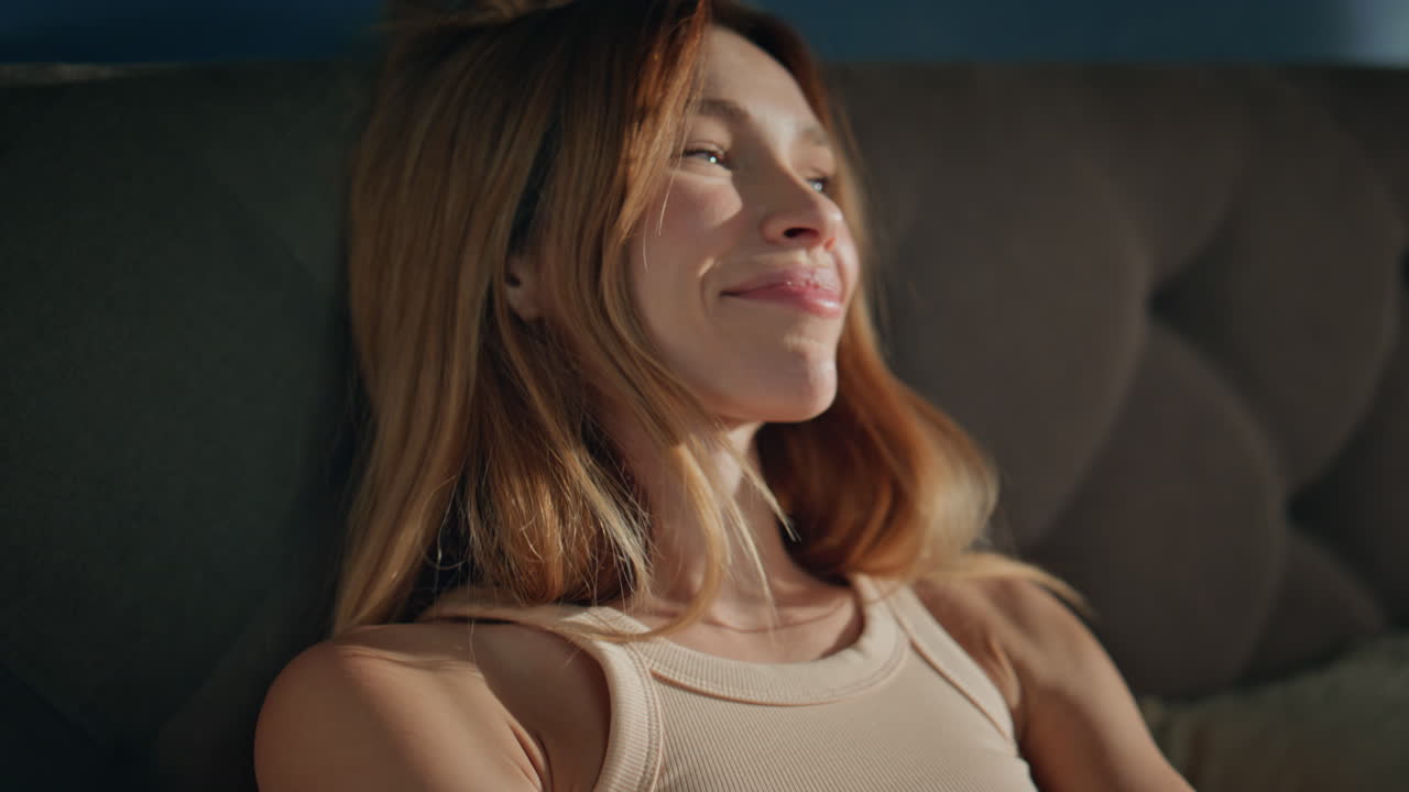 Morning girl reading cellphone message after wake up in cozy bed close up.