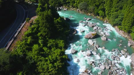 pristine mountain rivers in kochi japan, aerial tilt establishing shot of shikoku