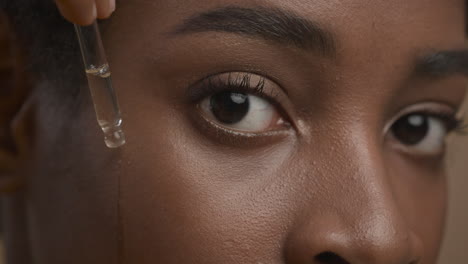 woman applying serum to face