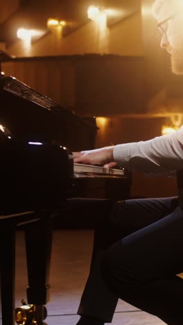 man playing piano in concert hall