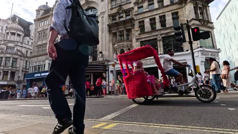 pedestrians and rickshaw on bustling london street