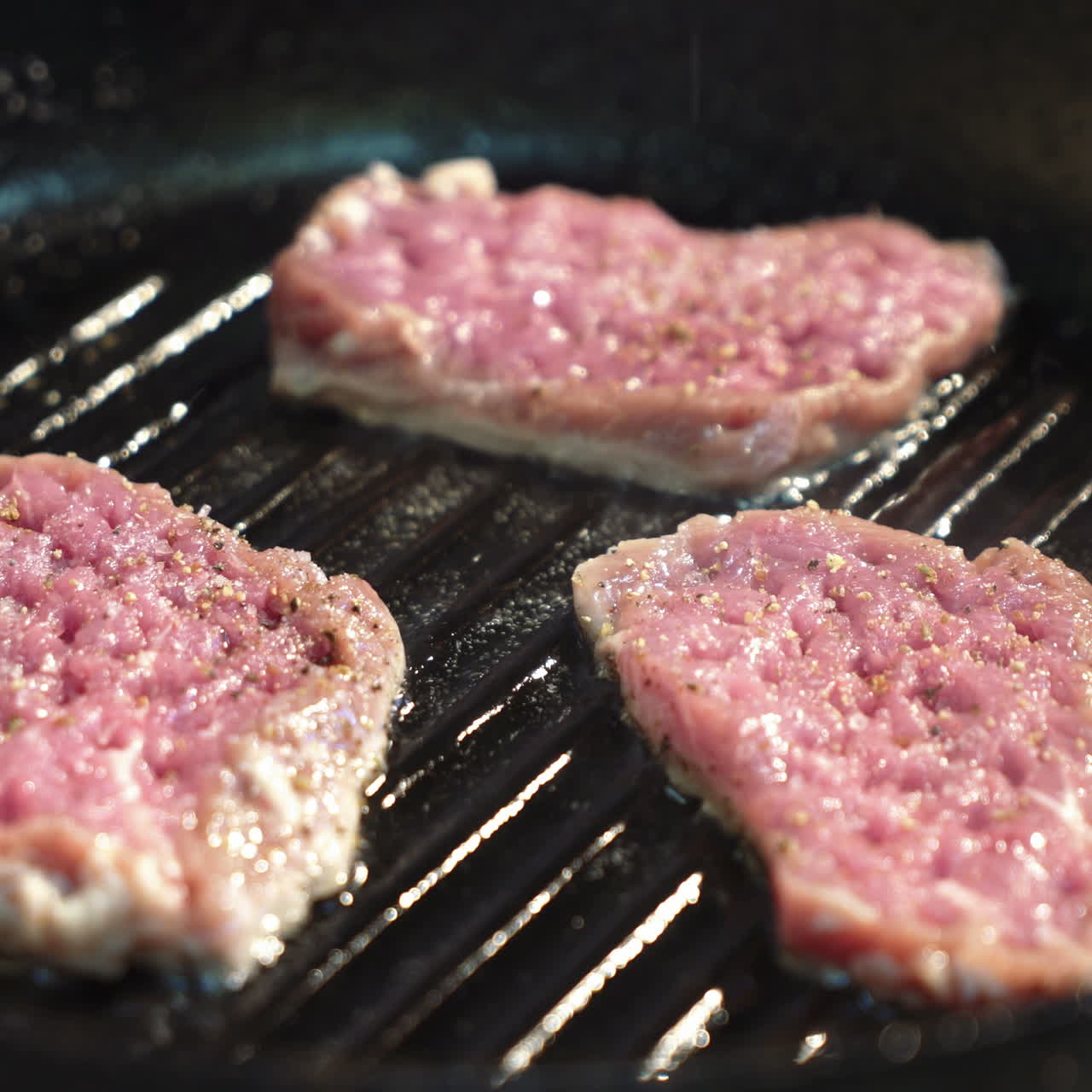 Seasoned sirloin steak in griddle pan. Sqare video