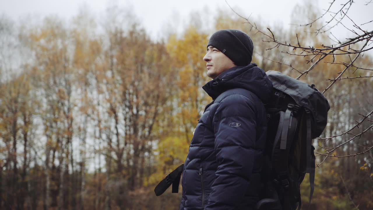 Walking male backpacker tourist. Travel and healthy lifestyle outdoors in fall season nature