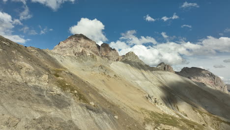 Large-aerial-shot-over-clouds-with-glacier-and-rocky-mountains-french-Alps