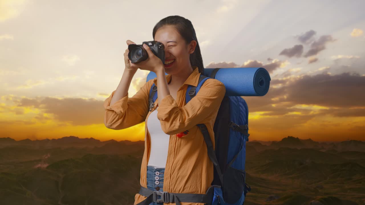 mujer tomando fotos en las montañas durante la puesta de sol