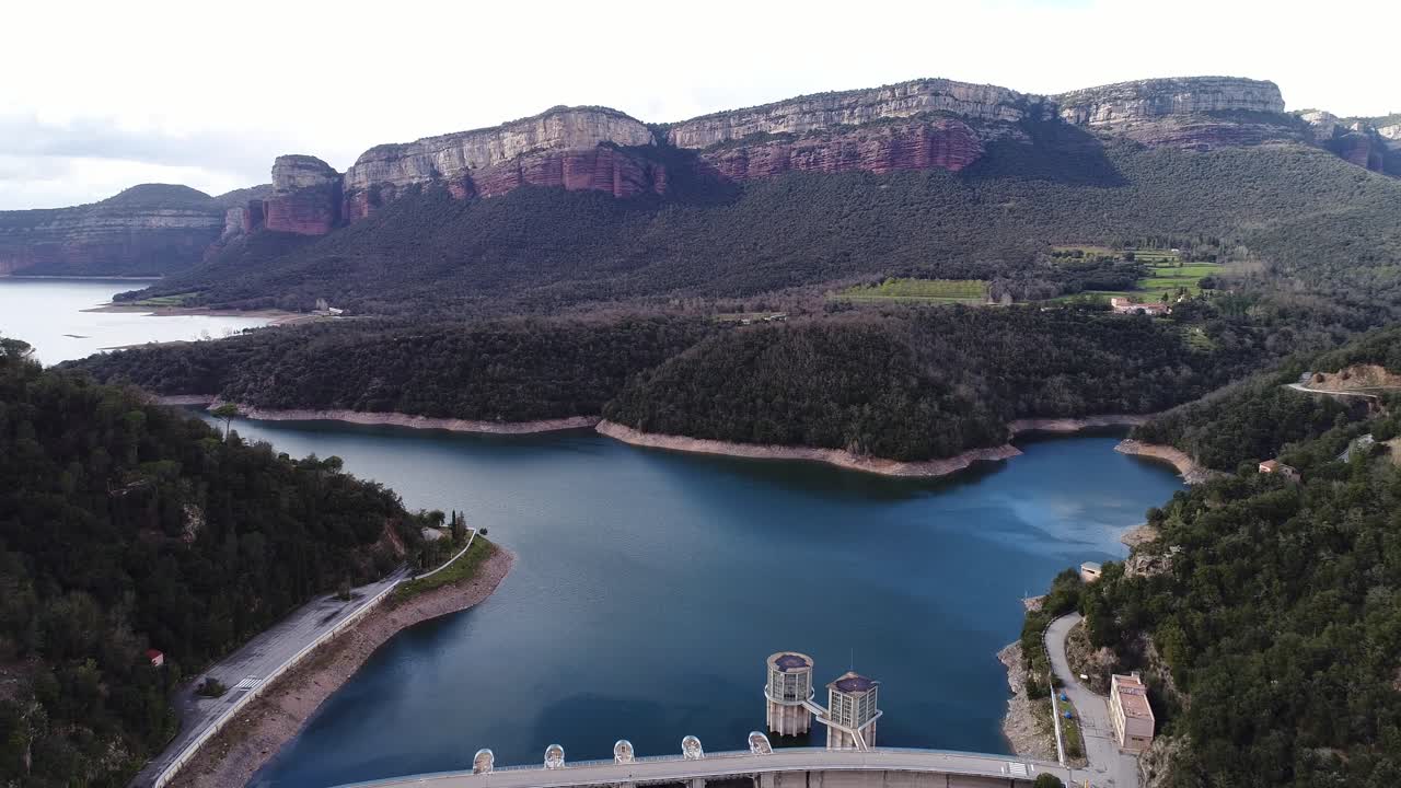 The impressive Sau Reservoir and dam nestled between cliffs in the Catalonia