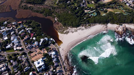 aerial arc shows scenic white beach and lagoon of touristic town onrus