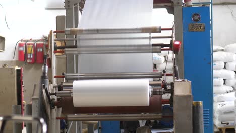 plastic cellophane bags going over rollers at factory