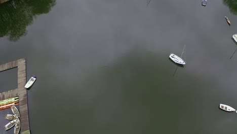 Beautiful-overhead-aerial-view,-footage-of-sailing-boats-on-Rudyard-Lake-in-the-Derbyshire-Peak-District-Nation-Park,-popular-holiday,-tourist-attraction-water-sports-on-offer,-peaceful,-calm-water