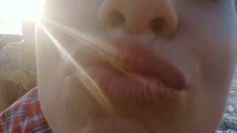 close-up of beautiful woman kissing at camera