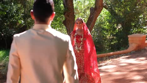 indian hindu groom and bride walking towards each other - close up