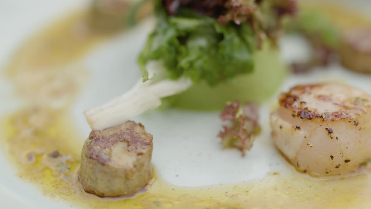 Close-up of an elegant scallop dish in a fine dining setting, with delicate garnishes and creamy sauce, captured in soft natural lighting and shallow depth of field