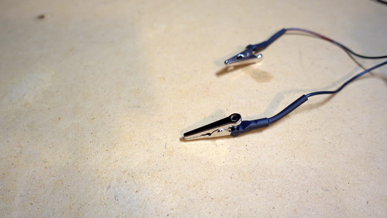 Alligator clips used to send electrical current into metal artifacts or tools for electrolytic cleaning