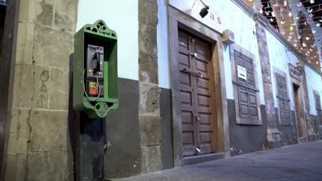 Old green telephone box in the street