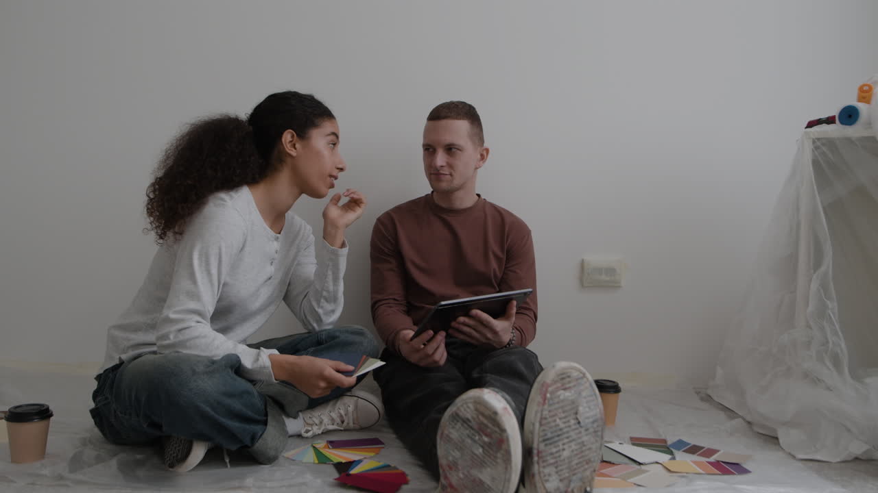 Young Couple Choosing Paint Colors for Home Renovation