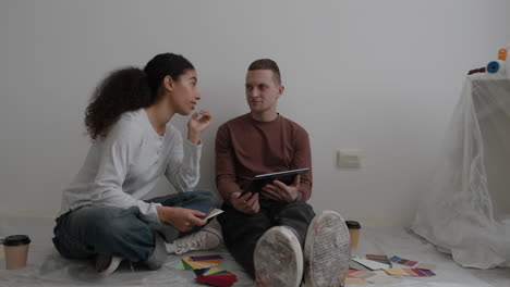 young couple choosing paint colors for home renovation