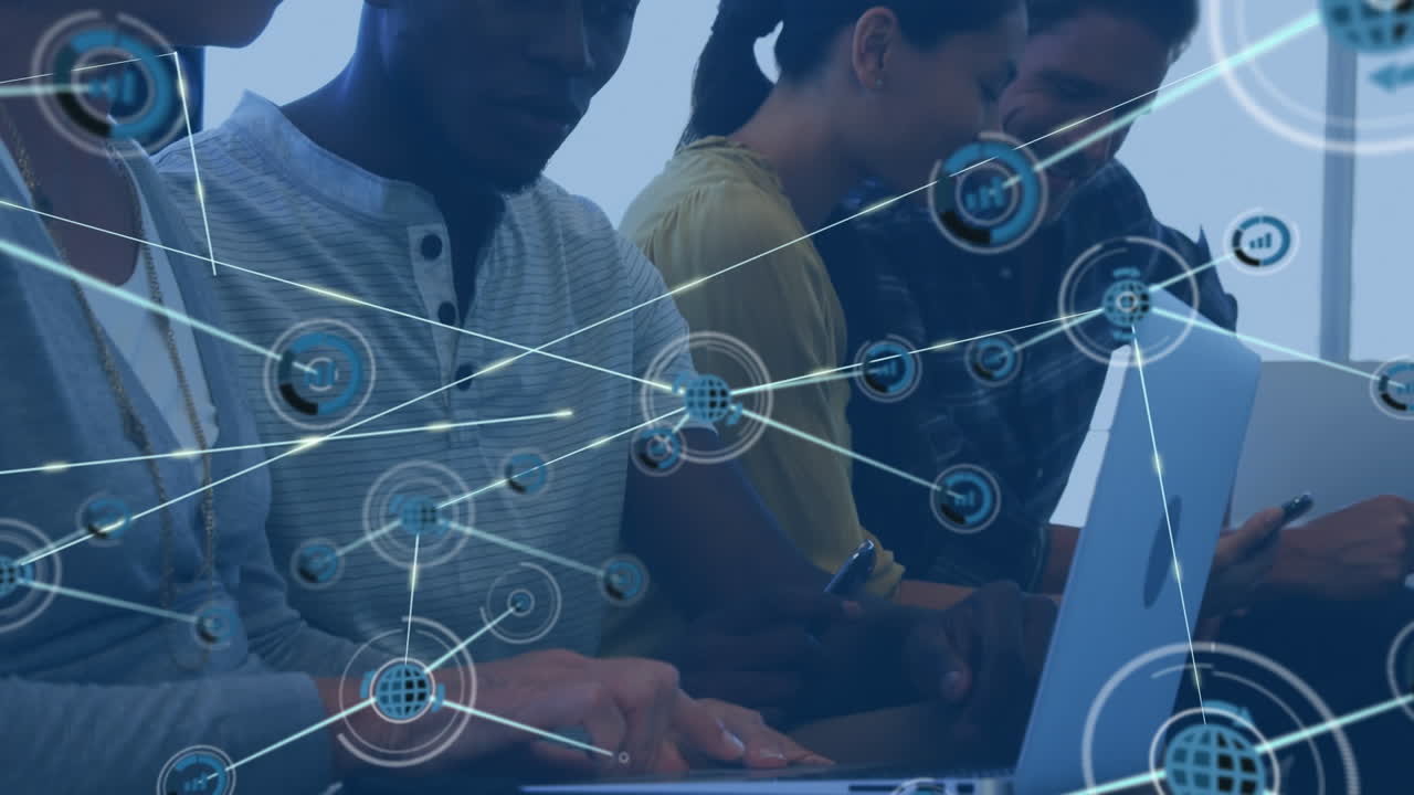 Animation of network of digital icons over diverse man and woman discussing over a laptop at office