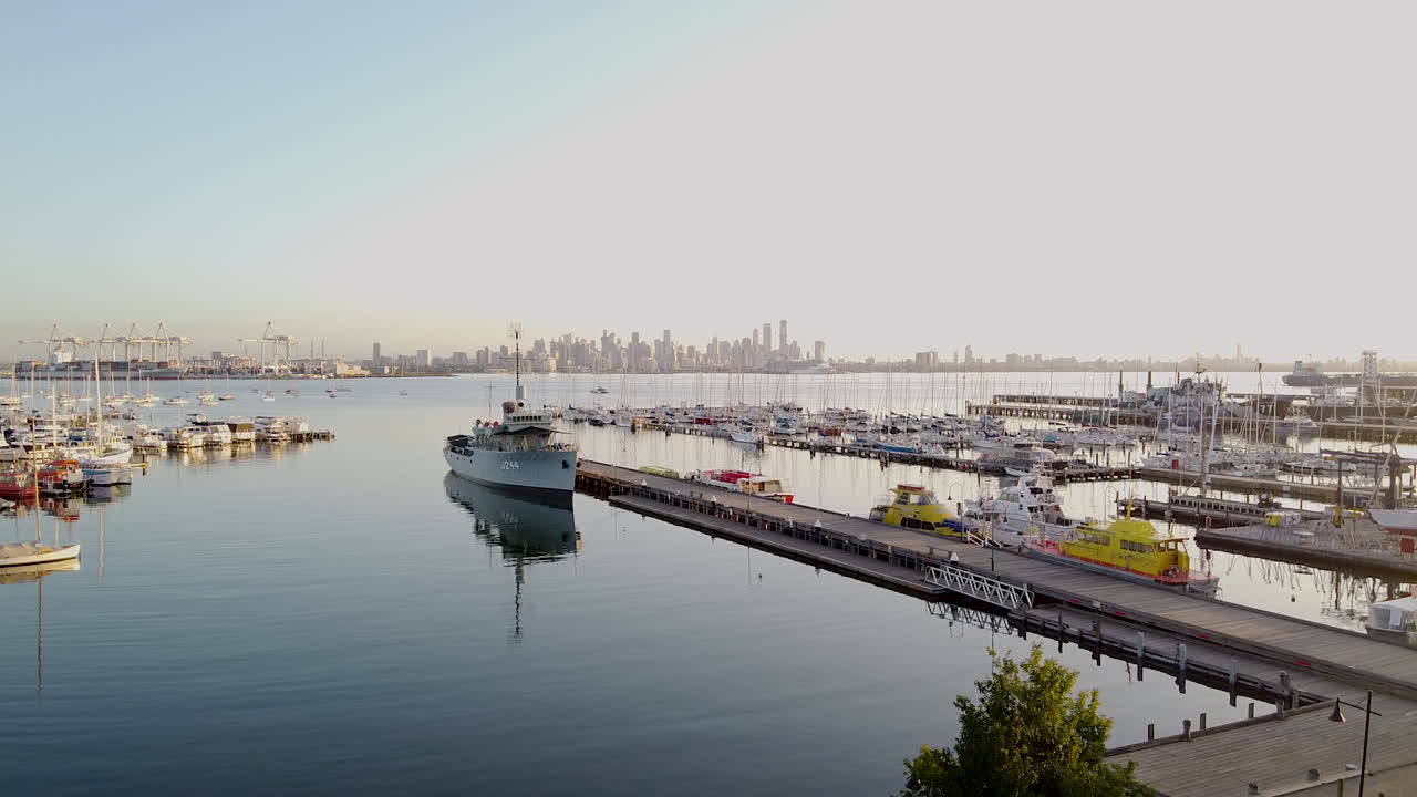 Australian Navy Ship J244. HMAS Castlemaine moored at Williamstown Melbourne with the city of Melbourne as a backdrop.