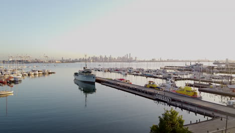 australian navy ship j244. hmas castlemaine moored at williamstown melbourne with the city of melbourne as a backdrop.