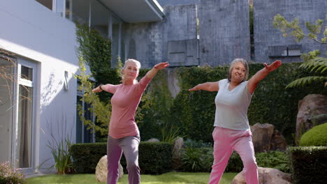 exercising outdoors, multiracial female friends stretching arms and enjoying fitness routine