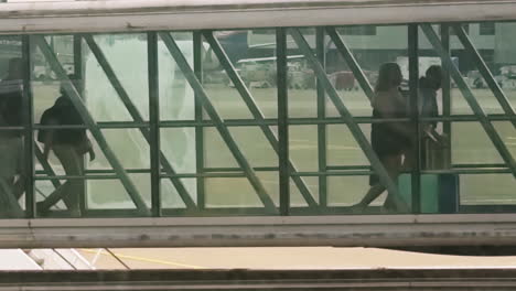 passengers exiting airplane using the sky bridge