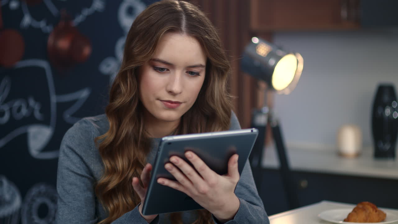 Portrait of focused business woman using tablet computer at home office.