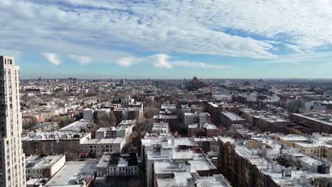 vertical drone ascending shot over ocean ave in brooklyn, showcasing new york’s vibrant rooftops, dynamic streets, and stunning skyline as the camera rises smoothly into the air.