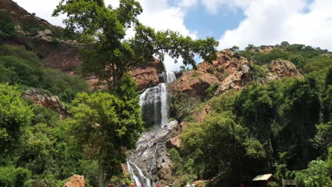 families enjoying a picnic and photos near waterfall at the walter sisulu national botanical gardens in roodepoort, south africa