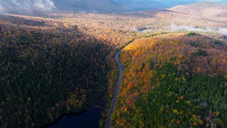 Vista-Aérea-De-Un-Lago-Rodeado-De-Colores-Máximos-De-Otoño-En-El-Norte-Del-Estado-De-Nueva-York