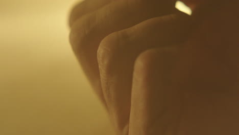 close-up of hands with warm lighting