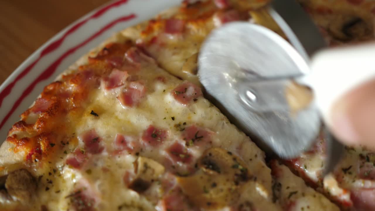 cutting cheese pizza macro closeup cheese ham mushrooms round cutter knife