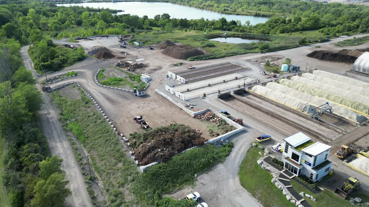Yard waste disposal pile at garbage centre with covered compost, aerial
