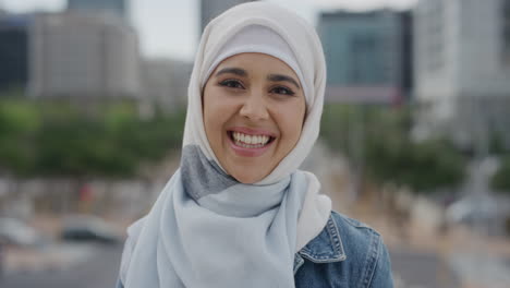 portrait young beautiful muslim woman laughing enjoying successful urban lifestyle independent female student wearing hijab headscarf in city wind blowing