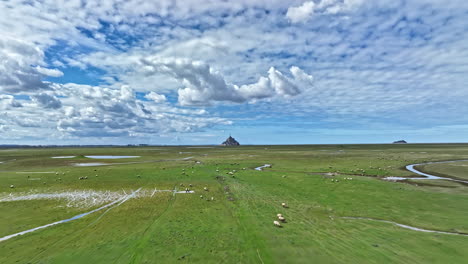 aerial shot of mont saint-michel: a symbol of faith and history by the sea.