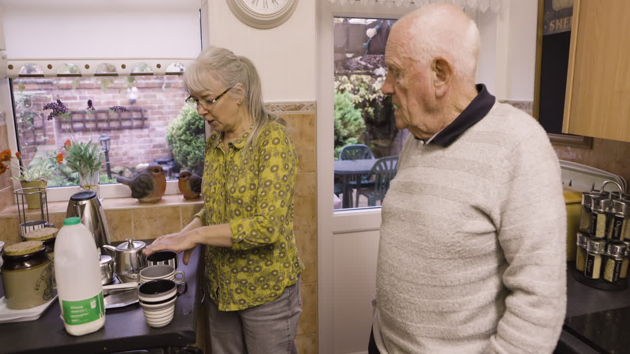 Elderly Couple Making Tea in Kitchen