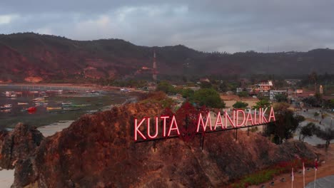 the sign of kuta mandalika during a sunrise