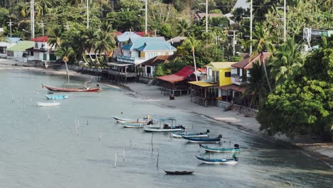 Nach-Unten-Neigen,-Drohnenaufnahmen-Von-Fischerbooten-Und-Strandhütten-Auf-Ko-Samui,-Thailand