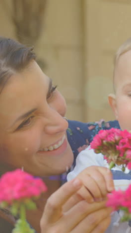 animation of glowing spots over happy caucasian mother with daughter holding flowers