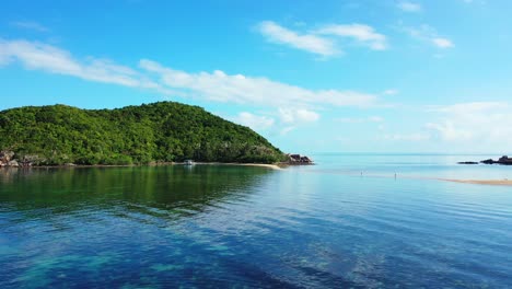 Peaceful-sea-lagoon-with-clear-water-and-coral-reefs-around-rocky-coastline-and-sandy-beaches-of-tropical-island-in-Thailand