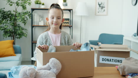 a young girl donates clothes and toys